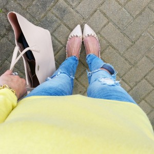 rockstud flats, blank denim jeans and yellow cowl neck sweater