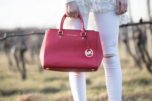 michael kors purse and white ripped jeans